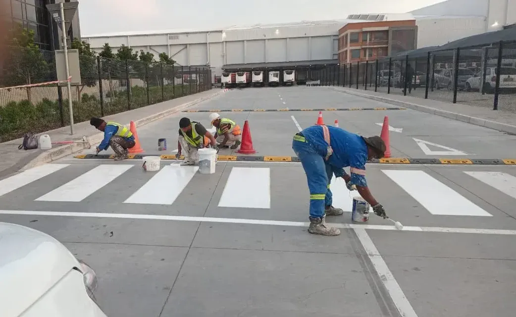 Our team hand-painting a pedestrian crossing at a logistics park in Cape Town